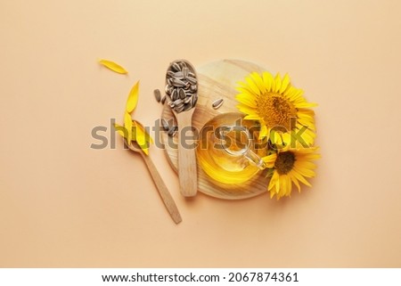 Composition with sunflower oil and seeds on color background