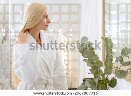 Young blonde Woman Brushing Her Hair
