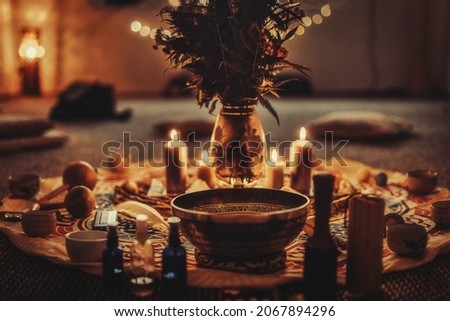 beautiful tibetan bowl and candles, ceremonial space. Royalty-Free Stock Photo #2067894296