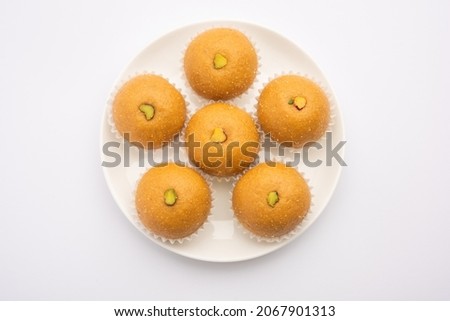 Besan ladoo are delicious sweet balls made with gram flour, sugar, ghee  cardamoms Royalty-Free Stock Photo #2067901313
