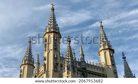 Spire of the Church in the medieval Gothic style. Gothic chapel. Top of the towers. Royalty-Free Stock Photo #2067913682