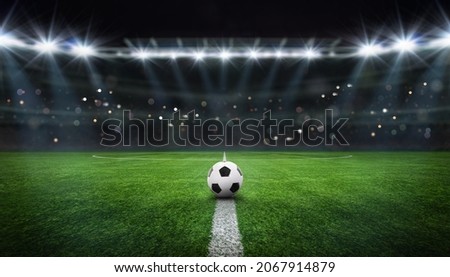 textured free soccer field in the evening light - center, midfield with the soccer ball Royalty-Free Stock Photo #2067914879