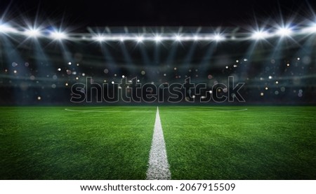 textured free soccer field in the evening light - center, midfield Royalty-Free Stock Photo #2067915509