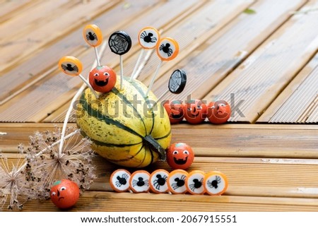 Halloween decorations background with pumpkins and sweets candies on the home wooden terrace 