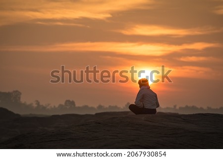 The sun rises in winter over the big rocks along the Mekong River with pictures of people and tourists Waiting to watch the sun rise at Sam Phan Bok, Ubon Ratchathani Province, Thailand