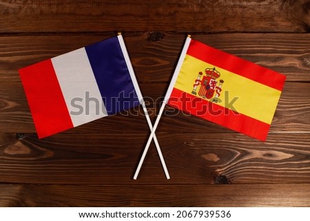Flag of France and flag of Spain crossed with each other. The image illustrates the relationship between countries. Photography for video news on TV and articles on the Internet and media.