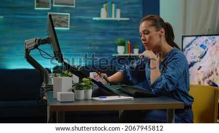 Professional editor using touch screen computer retouching pictures on editing software at studio. Photography artist working with technology and graphic tablet for image retouch.