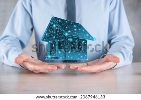Man hold low polygon.Real estate concept, businessman holding a house icon.House on Hand.Property insurance and security concept. Protecting gesture of man and symbol of house.