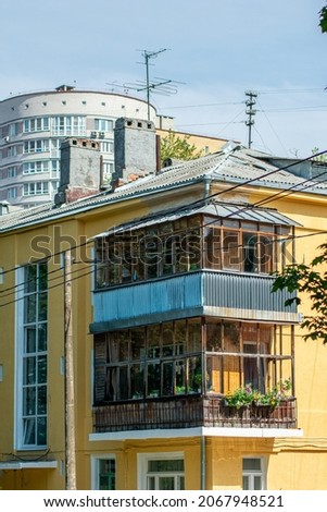 old small house on the background of a new building