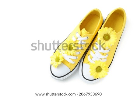 Yellow sneakers with flowers isolated on white background