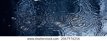 rain puddle circles, aqua abstract background, texture autumn water Royalty-Free Stock Photo #2067976256