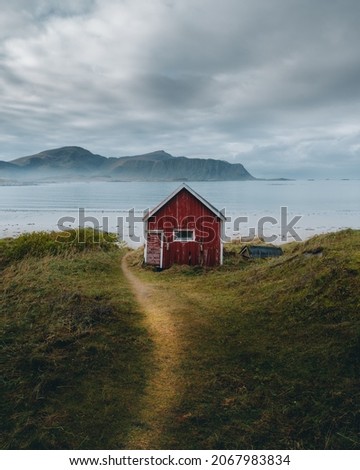 A typical red and colorful cottage of the Norwegian culture and architecture in Norway  Royalty-Free Stock Photo #2067983834