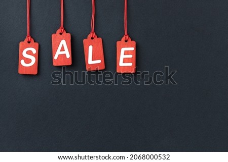 Black background for sales with red hanging labels