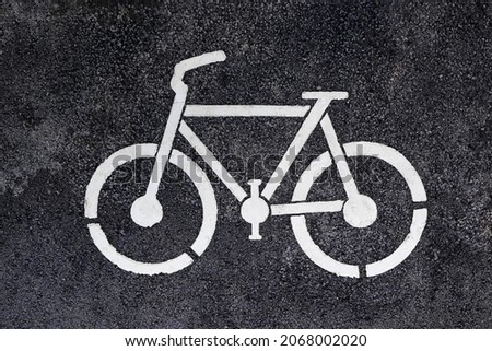 Symbol of White picture bike on the paved bicycle path. The new bicycle track. Bicycle road sign on asphalt. Bicycle Path.