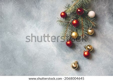 Christmas background with copy space. Christmas tree branches decorated with Christmas decorations. Top view.