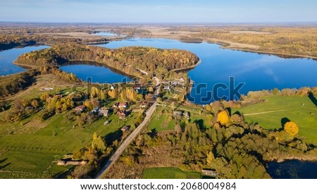 Top view autumn landscape with yellow trees on bank of lake. Nature concept. Space for text.