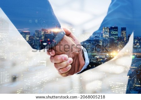 Partnership. multi exposure of investor businessman handshake with partner for successful meeting with night city background, digital technology, investment, negotiation, partnership, teamwork concept Royalty-Free Stock Photo #2068005218