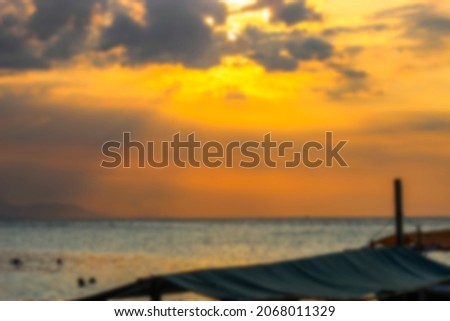 blur photo of view of the sunset on the beach with an amazing sky