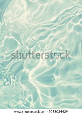 Closeup​ abstract​ of​ surface​ blue​ water​ for​ graphic​ design. Reflection​ of​ sunlight​ to​ surface​ blue​ water​ for​ background. Blue​ water​ splash​ed​ for​ background.