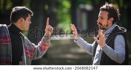 Close-up finger pointing of two very angry, nervous and upset men in an aggressive and fierce quarrel conflict on the verge of a physical confrontation and a fight. Concept of male conflict Royalty-Free Stock Photo #2068082147
