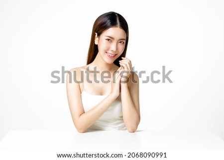 Asian woman with a beautiful face and fresh, smooth skin. Cute female model with natural makeup and sparkling eyes is posing and looking at the camera on white isolated background.
