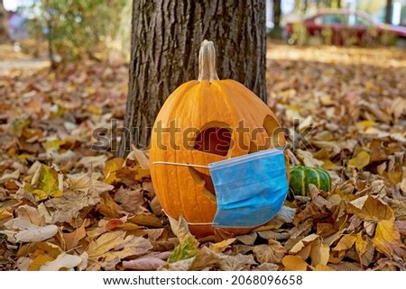 Pumpkin with a mask as a sign of corona virus protection.