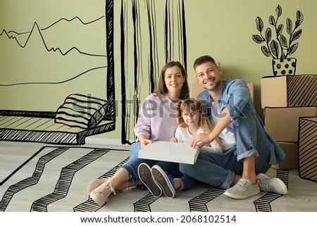 Happy family with pizza in their new house on moving day