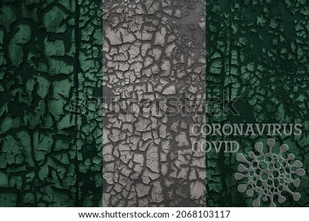 flag of nigeria on a old vintage metal rusty cracked wall with text coronavirus, covid, and virus picture.