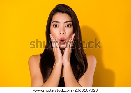 Photo of hooray brunette hairdo young lady hands cheeks wear black top isolated on yellow color background