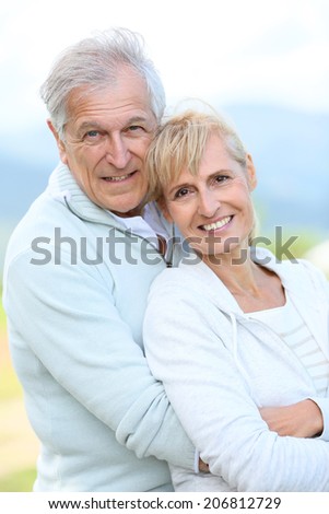 Portrait of cheerful senior couple embracing each other