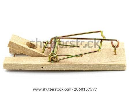 Macro photo of a spring loaded mousetrap, isolated on a white background, side view.
