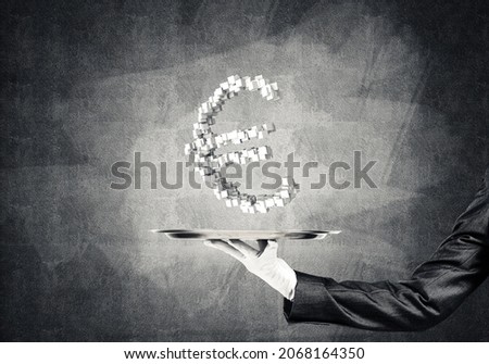 Cropped image of waitress's hand in white glove presenting multiple cubes in form of euro sign