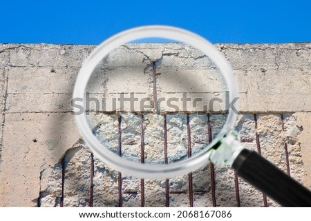 Old reinforced concrete structure with damaged and rusty metallic reinforcement that must be demolished - Concept seen through a magnifying glass