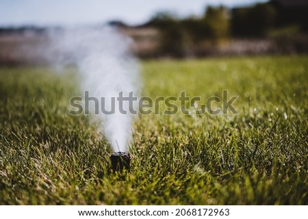 winterizing a irrigation sprinkler system by blowing pressurized air through to clear out water Royalty-Free Stock Photo #2068172963