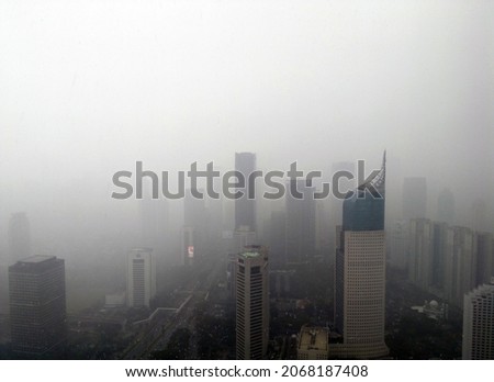 Noisy photo of air pollution in a city. Aerial view