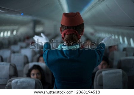 Cabin crew or air hostess working in airplane . Airline transportation and tourism concept. Royalty-Free Stock Photo #2068194518