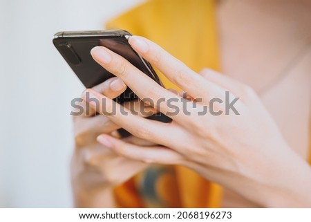 Young woman point finger while using a mobile phone by texting and typing the message to communicate with someone, copy space - Business, Lifestyle, Technology and Social Media Concept