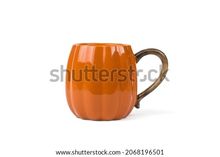 A large orange pumpkin-shaped mug isolated on a white background. Pumpkin style.