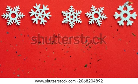 red Christmas background with a place for text and small white snowflakes on top , the concept of Christmas , black Friday