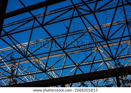 large steel frame against the blue sky
