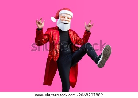 Happy man with funny low poly Santa's mask on colored background - Creative conceptual idea for advertising,adult with low-poly origami paper Santa Claus mask doing funny poses
