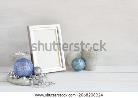 Christmas decoration, white frame mockup with christmas balls on a white table, copy space