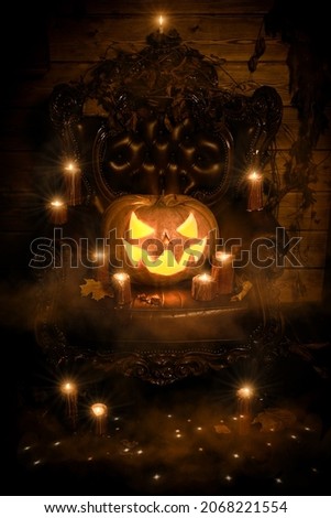 Mysterious Halloween. Photo of a pumpkin jack-o'-lantern with an evil smile on a vintage armchair in an old house surrounded by candles and magic lights. Fairy tale. Vintage style.
