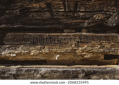 Closeup picture of old rustic wooden planks eaten by caries