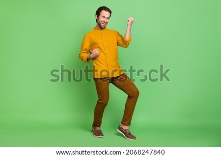 Full length photo of cool millennial guy yell wear shirt trousers shoes isolated on green color background