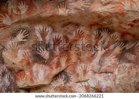 Prehistoric hand paintings at the Cave of the Hands (Spanish: Cueva de Las Manos ) in Santa Cruz Province, Argentine Patagonia. The art in the cave dates from 13,000 to 9,000 years ago.