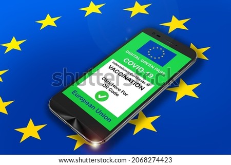 smartphone with the digital green pass of the European Union with the QR code on the screen with a EU flag in the background