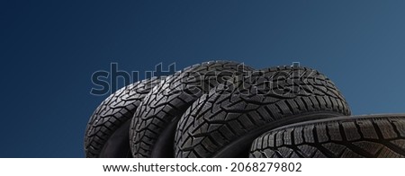 Winter car tires. Group of tires for winter driving on a blue background.