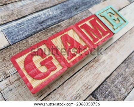 Game. The word game from wooden letter blocks. Fit for educational media, teaching, childrens book, etc