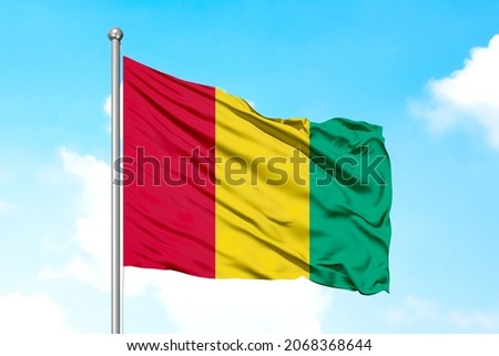 Guinea Flying Flag flying flag on a clear sky for designer